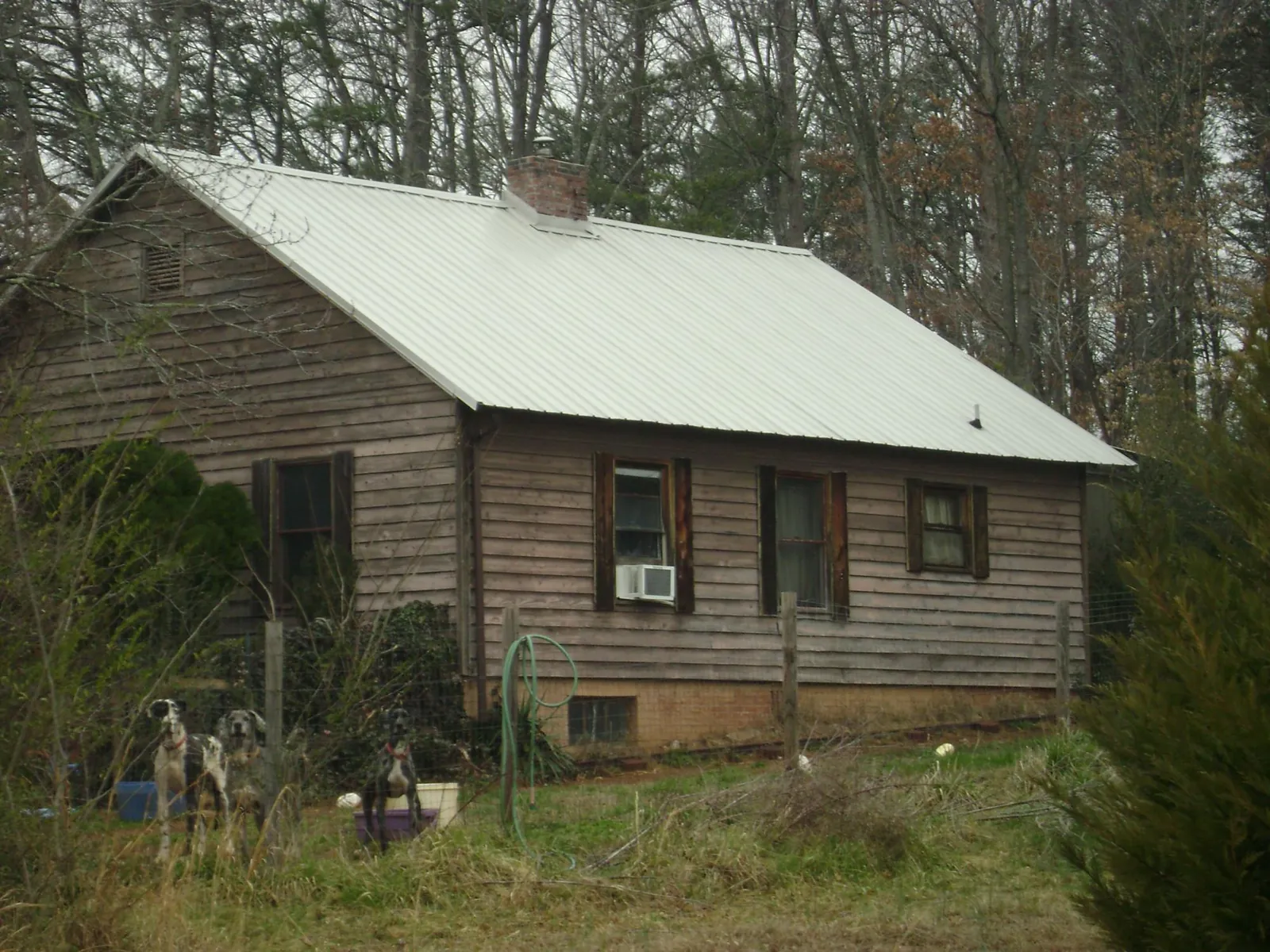 White metal roof on an old wood sided farmhouse, from a Metal Roof Installation job in Nashua